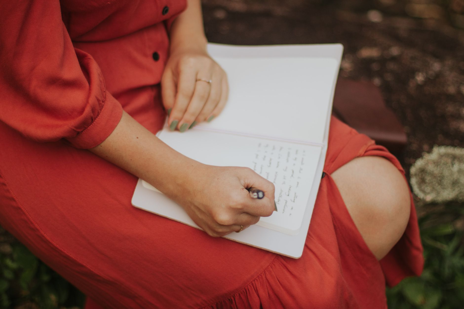 Author writing notes overlooking a valley